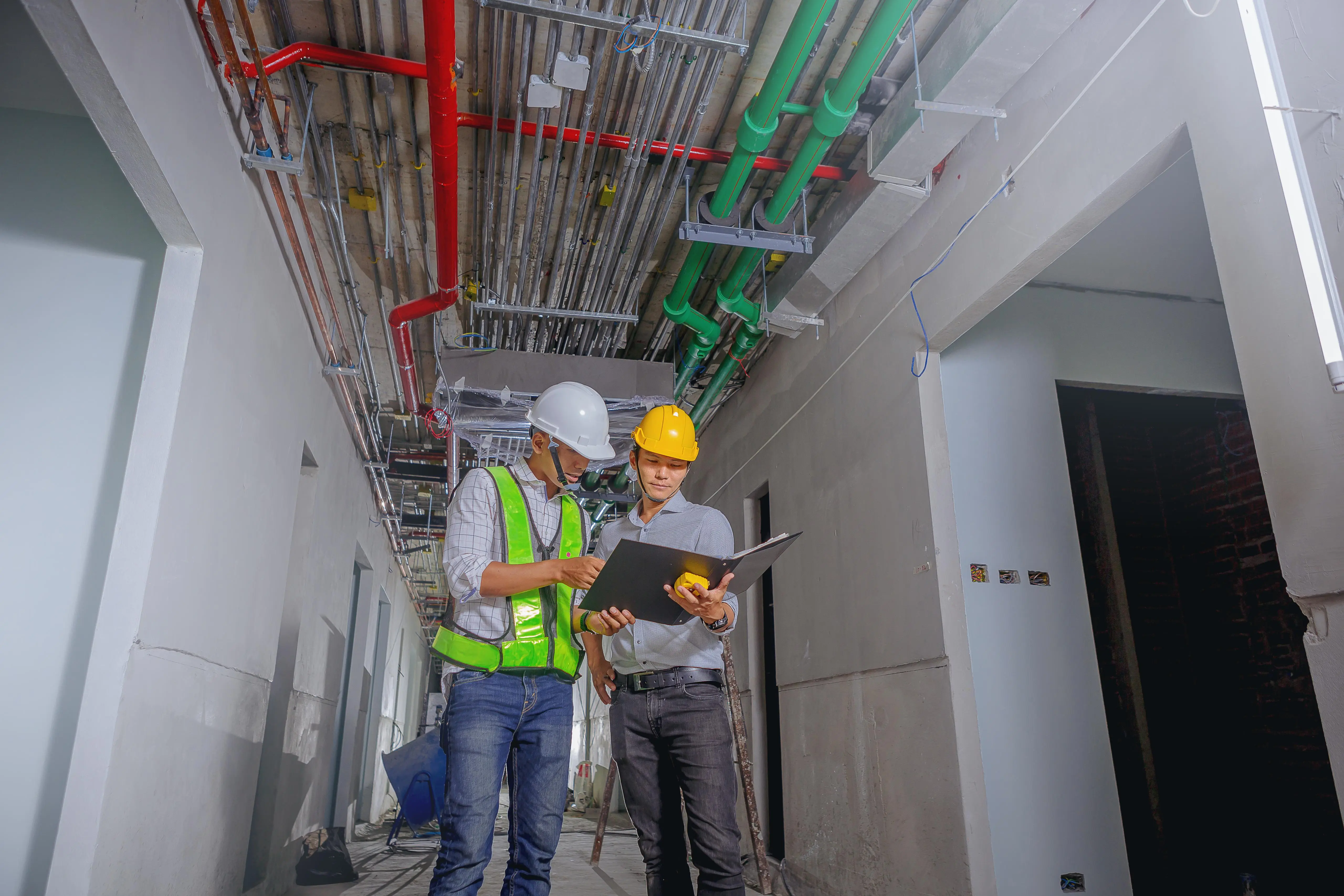 Two international professionals discussing on a construction site